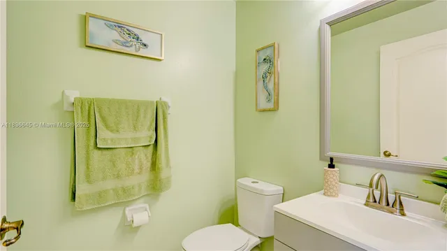 a white toilet sitting next to a bathroom sink