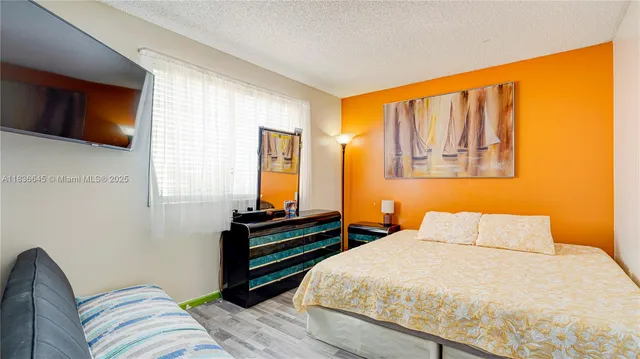 a bedroom with a bed and dresser