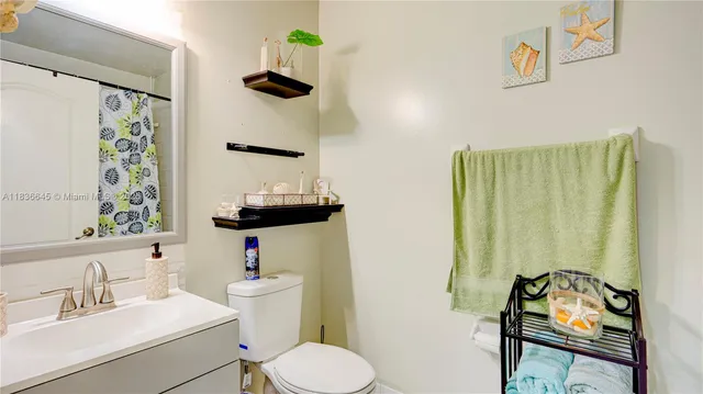 a bathroom with a sink toilet and a mirror