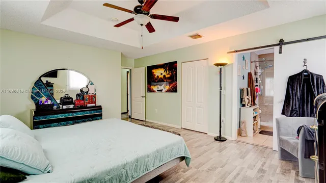 a bedroom with bed and a chandelier