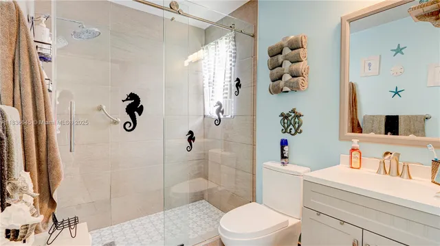 a bathroom with a sink vanity granite toilet and shower
