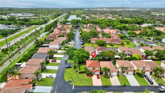 an aerial view of residential houses with outdoor space and street view