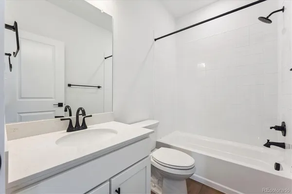 a bathroom with a sink a toilet and a bathtub