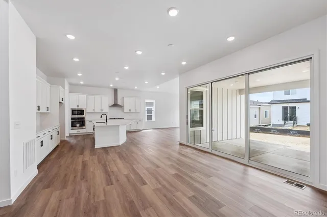 a open kitchen with white cabinets and stainless steel appliances