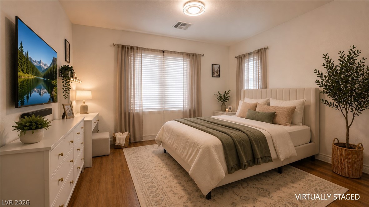 87 Tall Ruff Drive Las Vegas, NV 89148 - Photo 65 of 71 A well-lit bedroom features hardwood floors and a wide window with natural illumination.