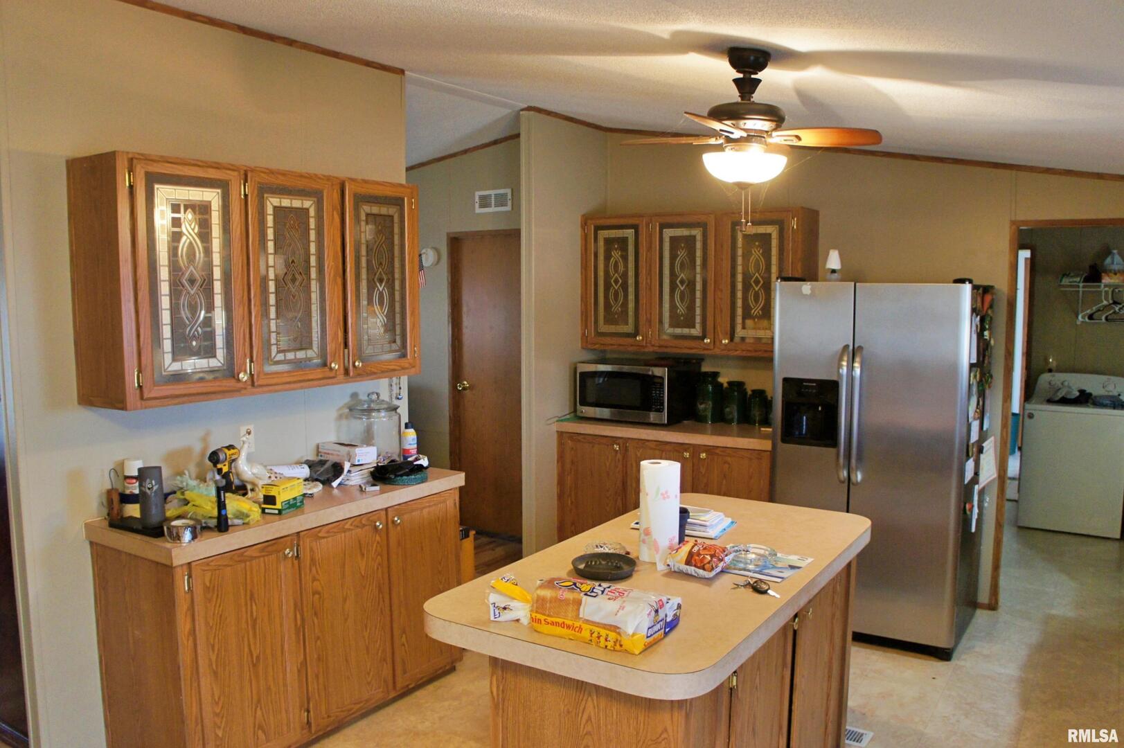 6752 South US 45 Road Brookport, IL 62910 - Photo 16 of 62 a kitchen with stainless steel appliances granite countertop a sink refrigerator and cabinets
