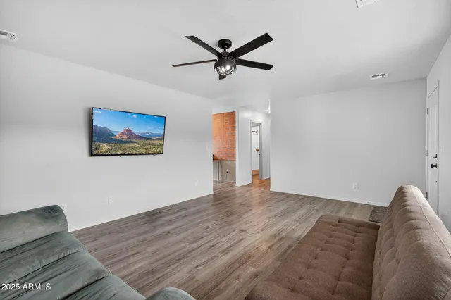 a bedroom with a large bed and a potted plant