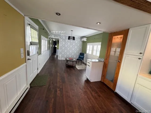 a hallway with wooden floor and furniture