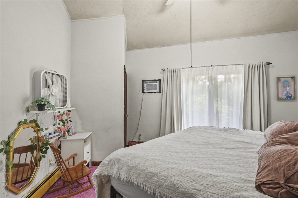77 Vinton Road Holland, MA 01521 - Photo 11 of 31 a bedroom with a bed and a table in it