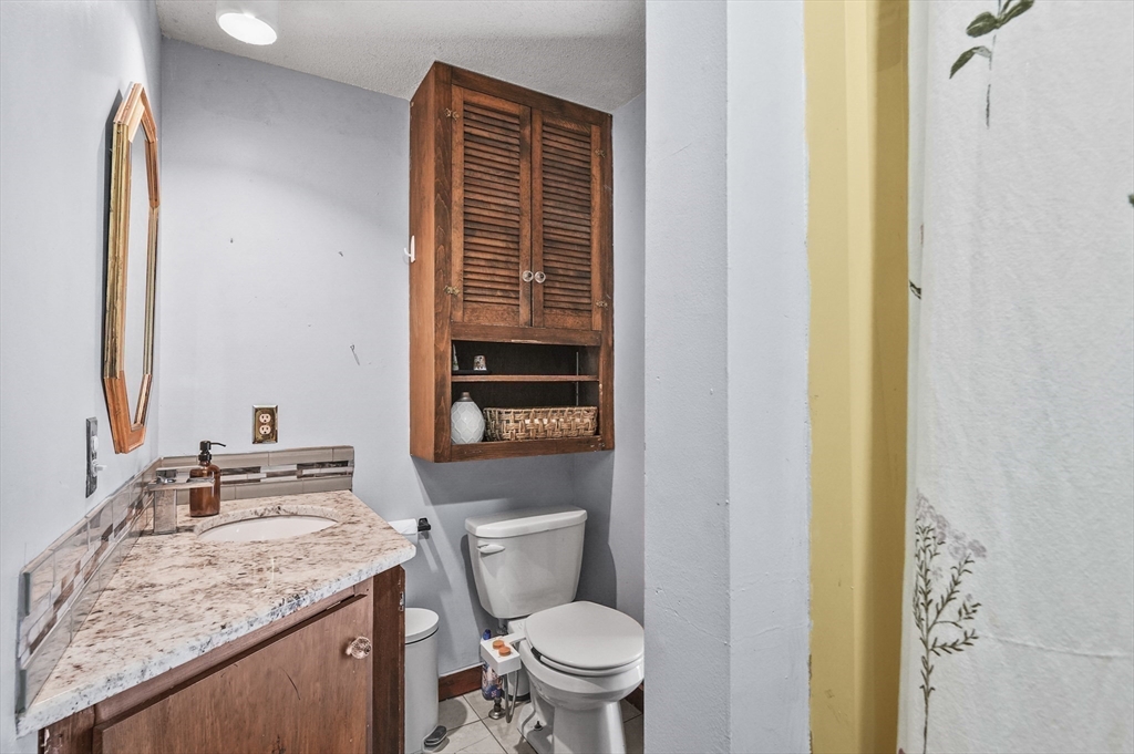 77 Vinton Road Holland, MA 01521 - Photo 12 of 31 a bathroom with a granite countertop sink toilet and mirror