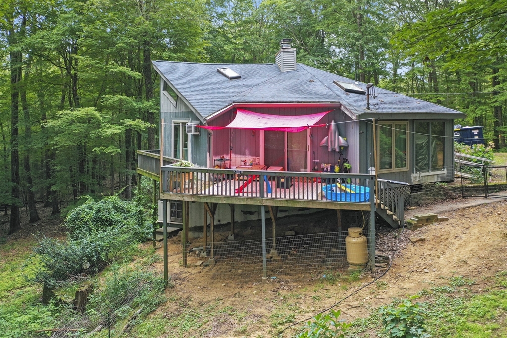 77 Vinton Road Holland, MA 01521 - Photo 26 of 31 an outdoor cafe with a table and chairs under an umbrella