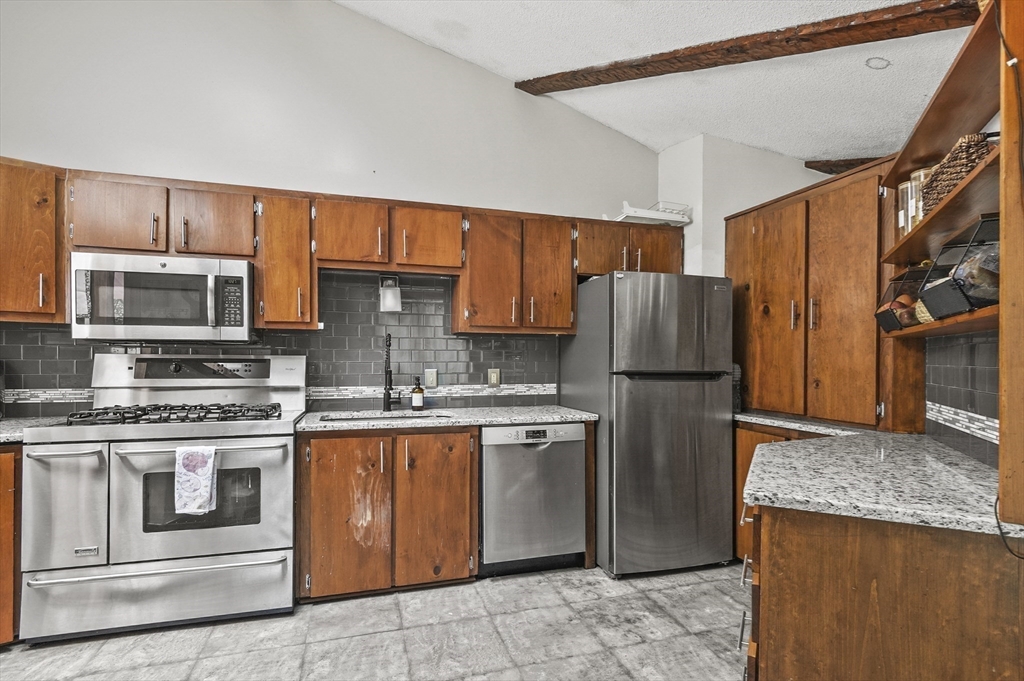 77 Vinton Road Holland, MA 01521 - Photo 8 of 31 a kitchen with stainless steel appliances granite countertop a refrigerator stove and microwave