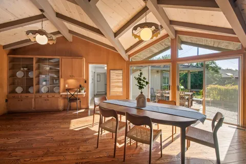 a view of a dining room with furniture wooden floor and a chandelier