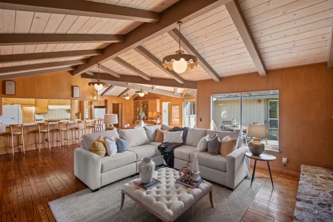 a living room with furniture and wooden floors