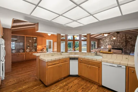 a open kitchen with a sink and cabinets