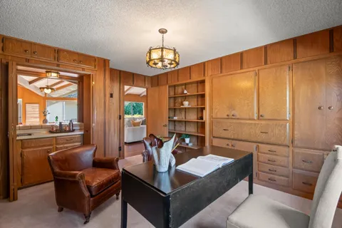 a living room with furniture a fireplace and a chandelier