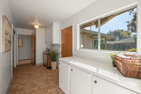 a spacious bedroom with a bed a couch and a large window