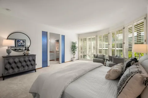a bathroom with a granite countertop sink mirror vanity and toilet
