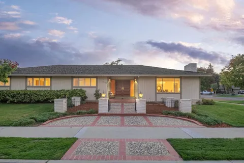 a front view of a house with garden