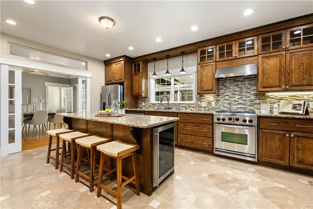 a kitchen with granite countertop a stove and a microwave