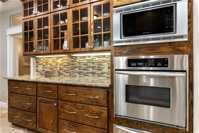 a bathroom with a granite countertop sink and a toilet