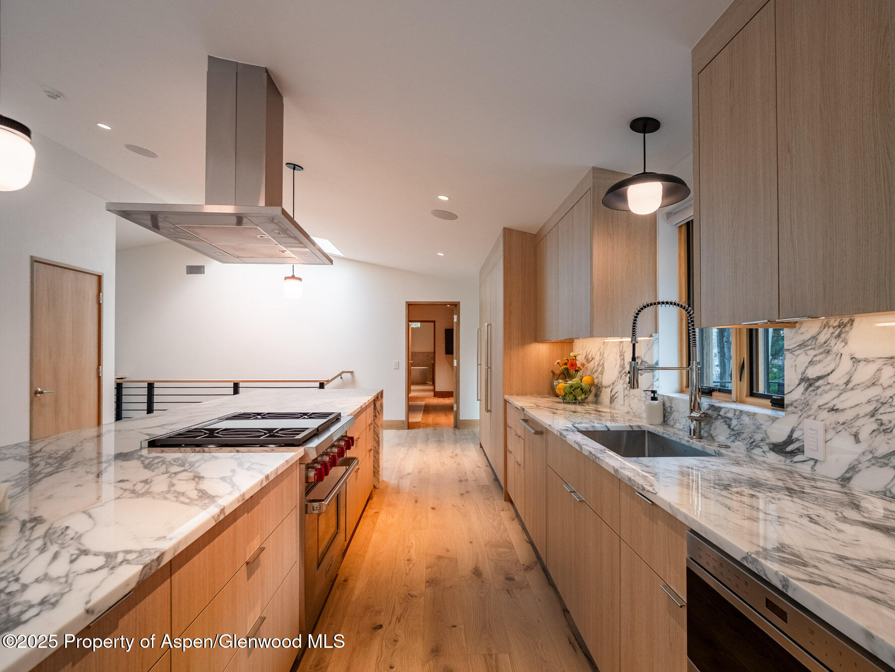 51 Roaring Fork Drive Aspen, CO 81611 - Photo 14 of 30 a kitchen with stainless steel appliances granite countertop a sink a stove and a wooden floors