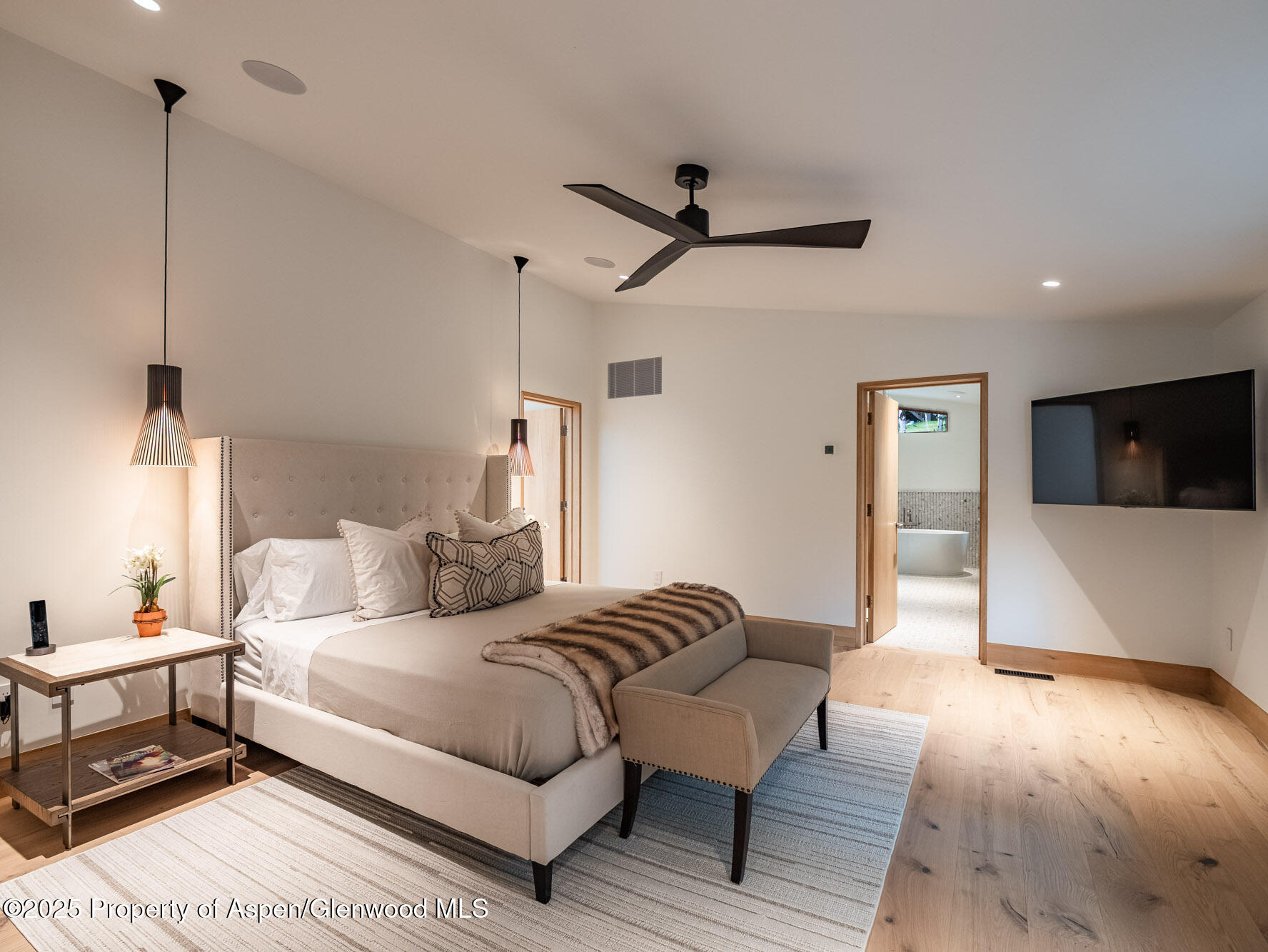 51 Roaring Fork Drive Aspen, CO 81611 - Photo 16 of 30 a spacious bedroom with a bed and a flat screen tv