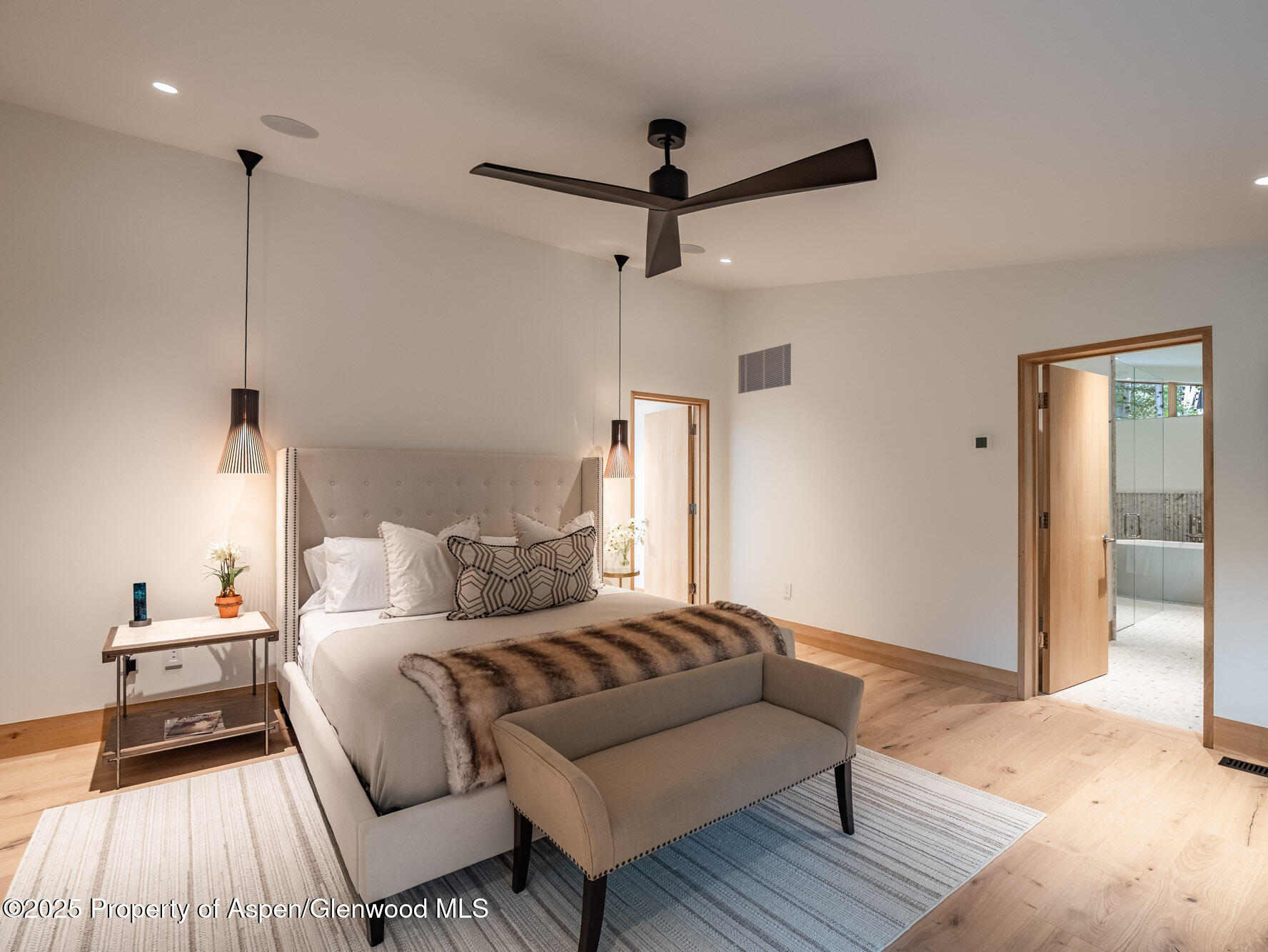 51 Roaring Fork Drive Aspen, CO 81611 - Photo 17 of 30 a bedroom with a bed and wooden floor