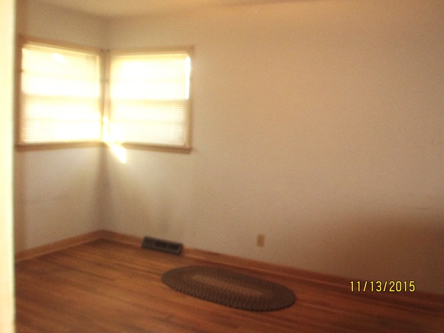 2223 Garden Road Aurora, IL 60506 - Photo 7 of 12 a view of empty room with wooden floor and fan
