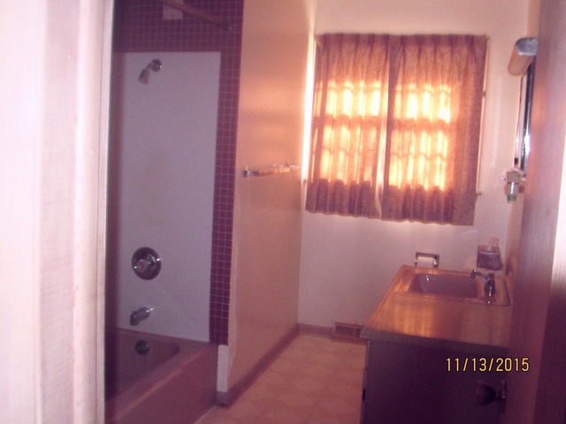 2223 Garden Road Aurora, IL 60506 - Photo 8 of 12 a bathroom with a granite countertop sink a mirror and a shower