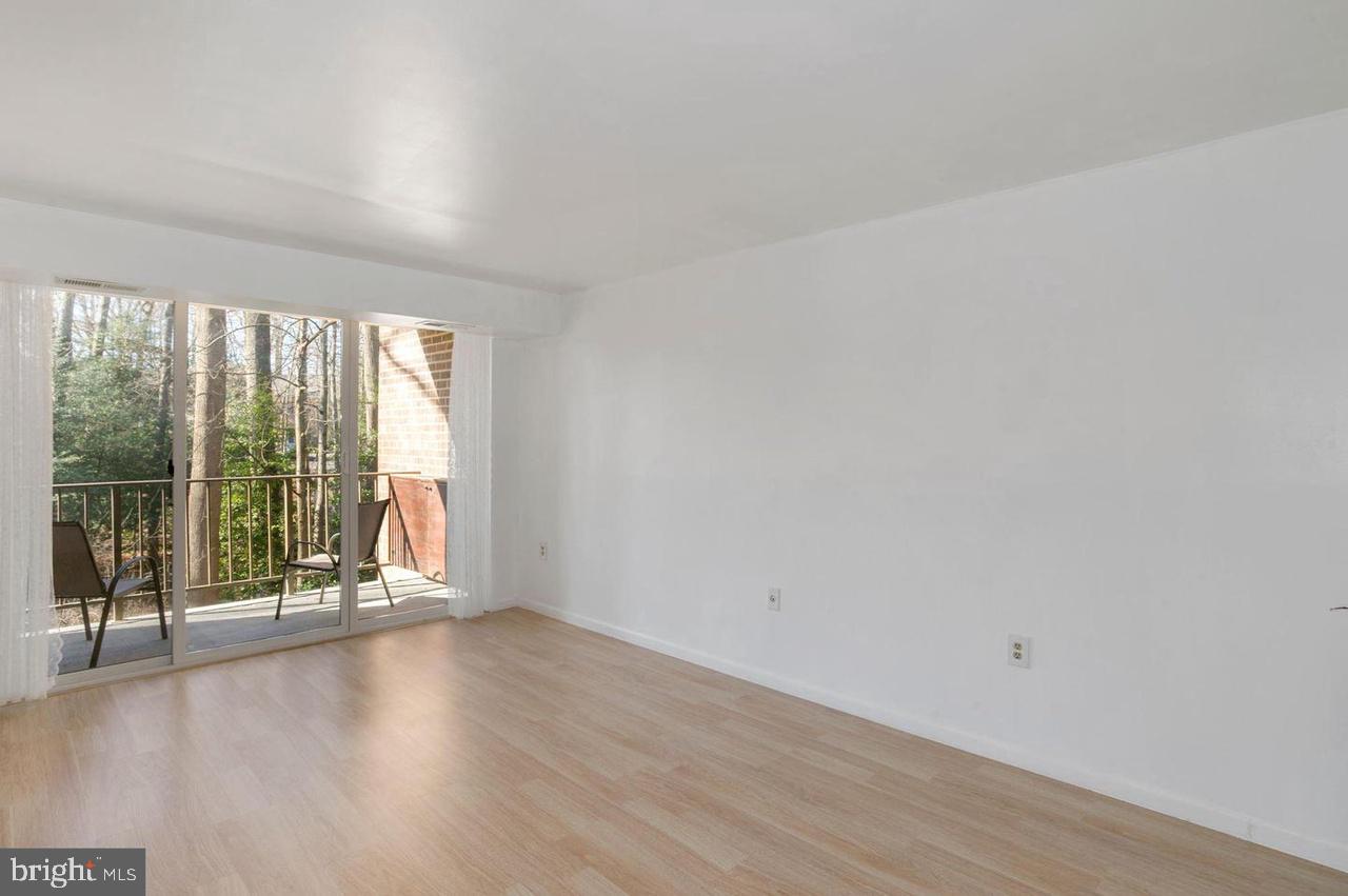 1532 Northgate Square, Unit 12A Reston, VA 20190 - Photo 3 of 20 a view of an empty room with wooden floor and a window