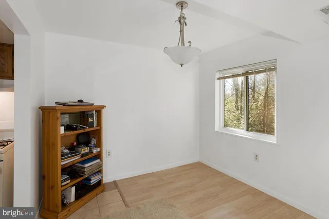 a view of an empty room with closet and window