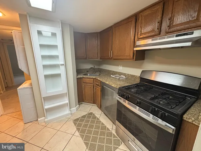 a stove top oven sitting inside of a kitchen