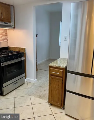 a kitchen with a stove top oven and cabinets