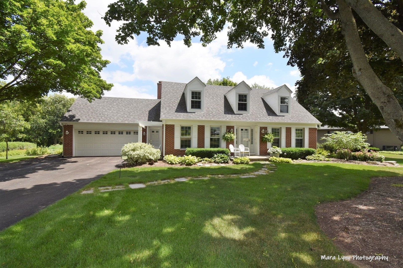 6-n143 Woodland Road St. Charles, IL 60175 - Photo 1 of 17 a front view of a house with garden and porch