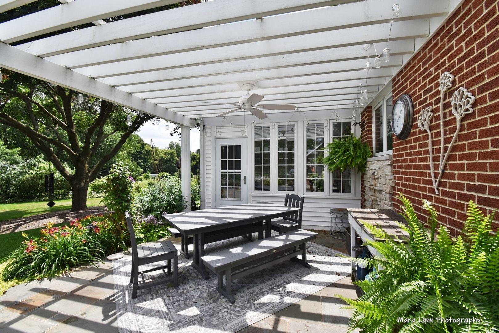 6-n143 Woodland Road St. Charles, IL 60175 - Photo 12 of 17 a view of a patio with table and chairs and potted plants