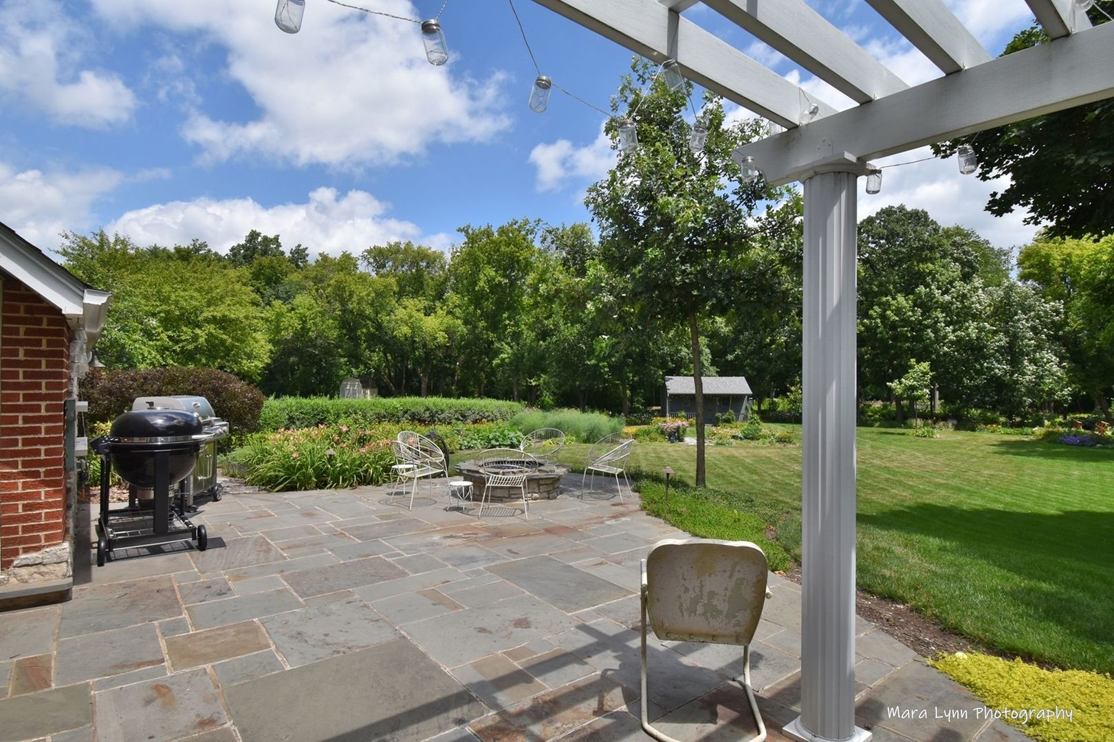 6-n143 Woodland Road St. Charles, IL 60175 - Photo 13 of 17 a view of a chair and tables in the garden
