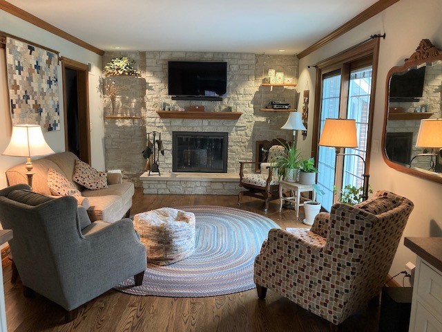 6-n143 Woodland Road St. Charles, IL 60175 - Photo 6 of 17 a living room with furniture a flat screen tv and a fireplace