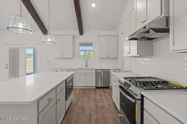a spacious bathroom with a granite countertop sink a toilet and a shower