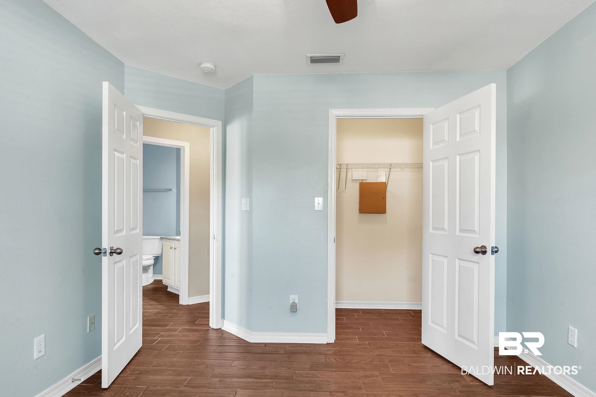 16444 Hamlet Lane Foley, AL 36535 - Photo 31 of 49 Unfurnished bedroom with dark wood finished floors, a walk in closet, and visible vents