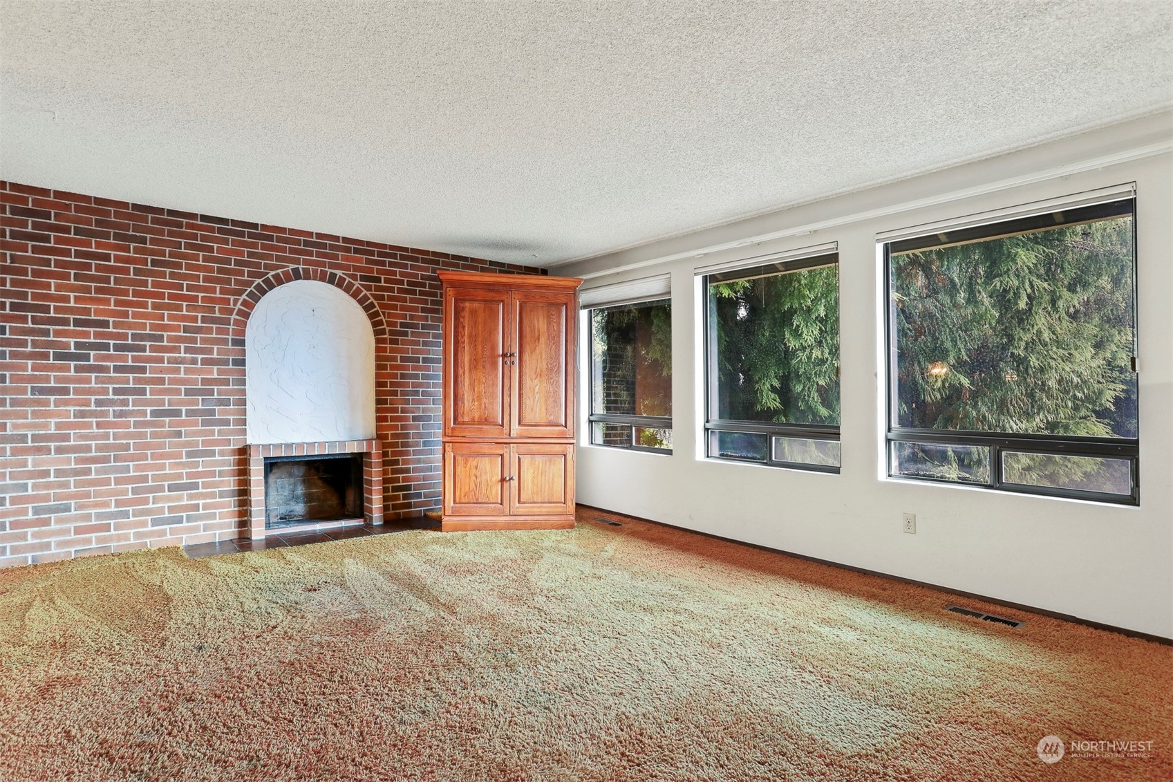 22224 4th Avenue Southeast Bothell, WA 98021 - Photo 3 of 23 a view of an empty room with a fireplace and a window