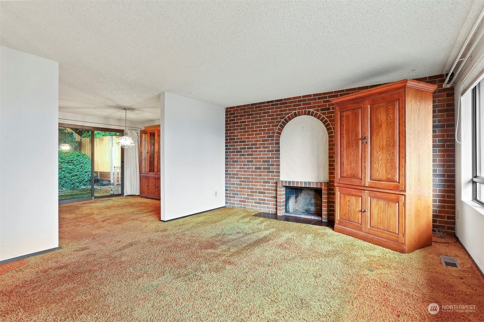 22224 4th Avenue Southeast Bothell, WA 98021 - Photo 4 of 23 a view of an empty room with a fireplace and a window
