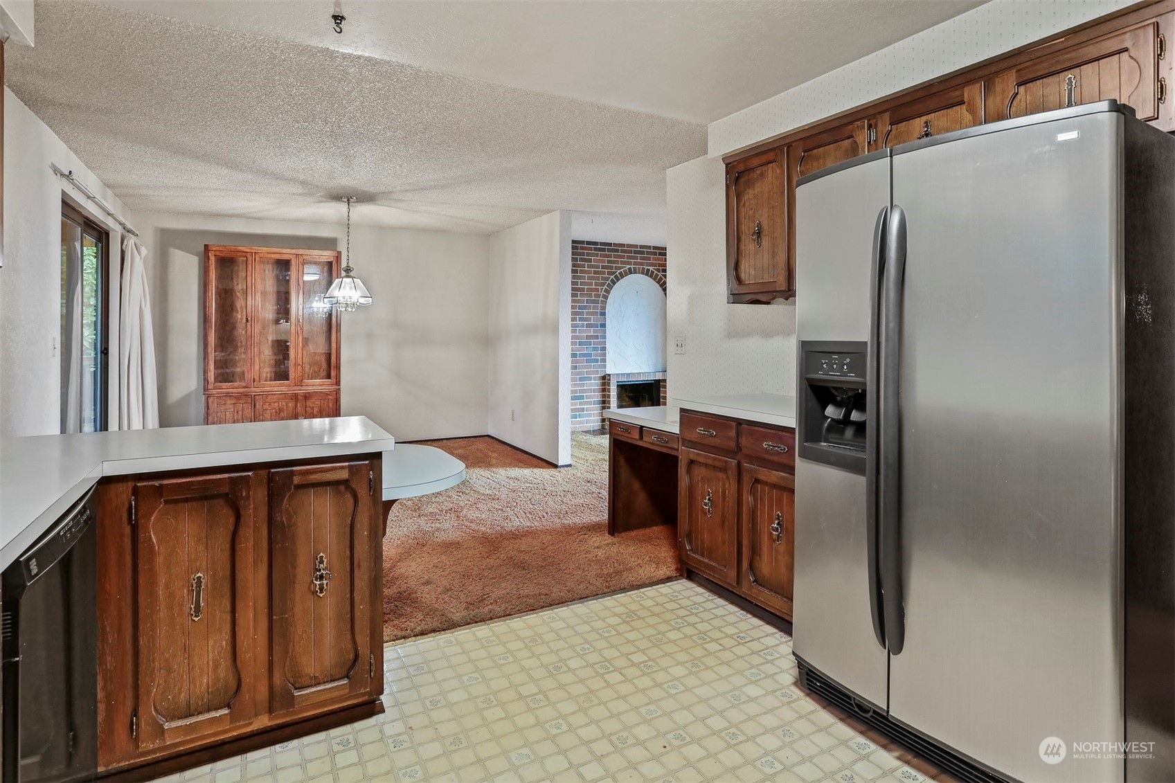 22224 4th Avenue Southeast Bothell, WA 98021 - Photo 6 of 23 a kitchen with granite countertop a refrigerator and a stove top oven