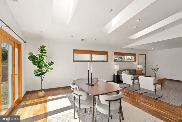 a dining room with furniture and wooden floor