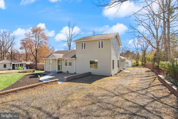 a living room with furniture a wooden floor and next to a window