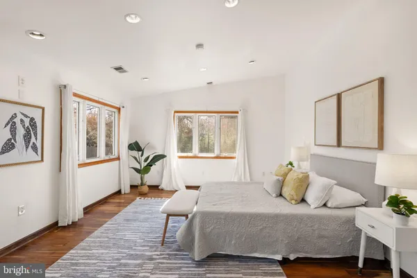 a spacious bedroom with a bed and a table