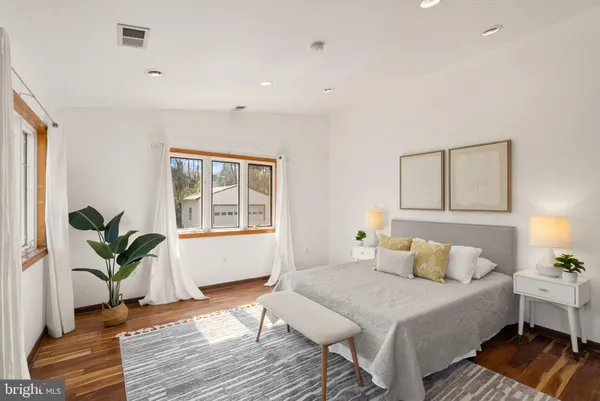 a bedroom with a large bed and a window