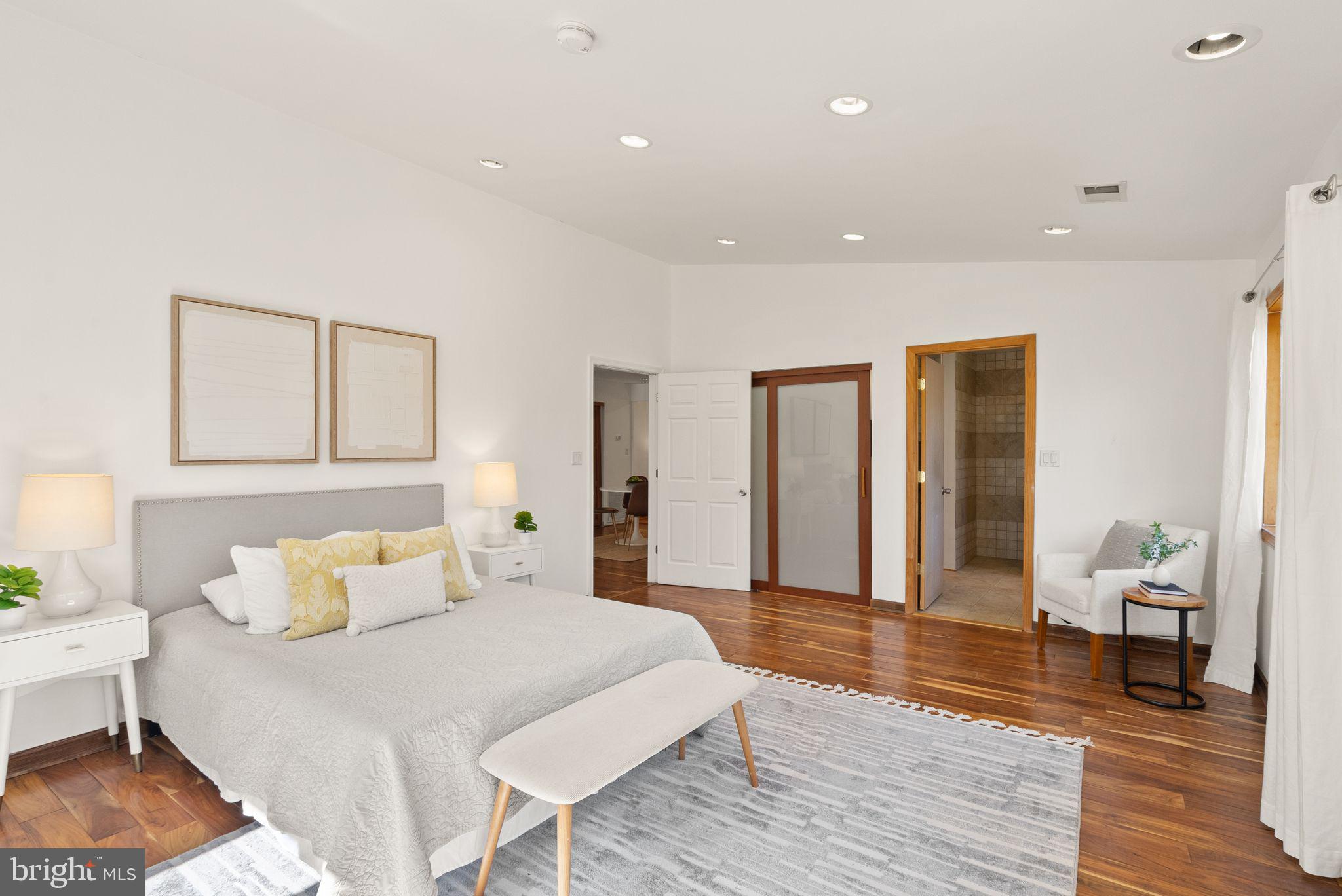 8737 Redman Street Springfield, VA 22153 - Photo 27 of 62 a spacious bedroom with a bed and a table