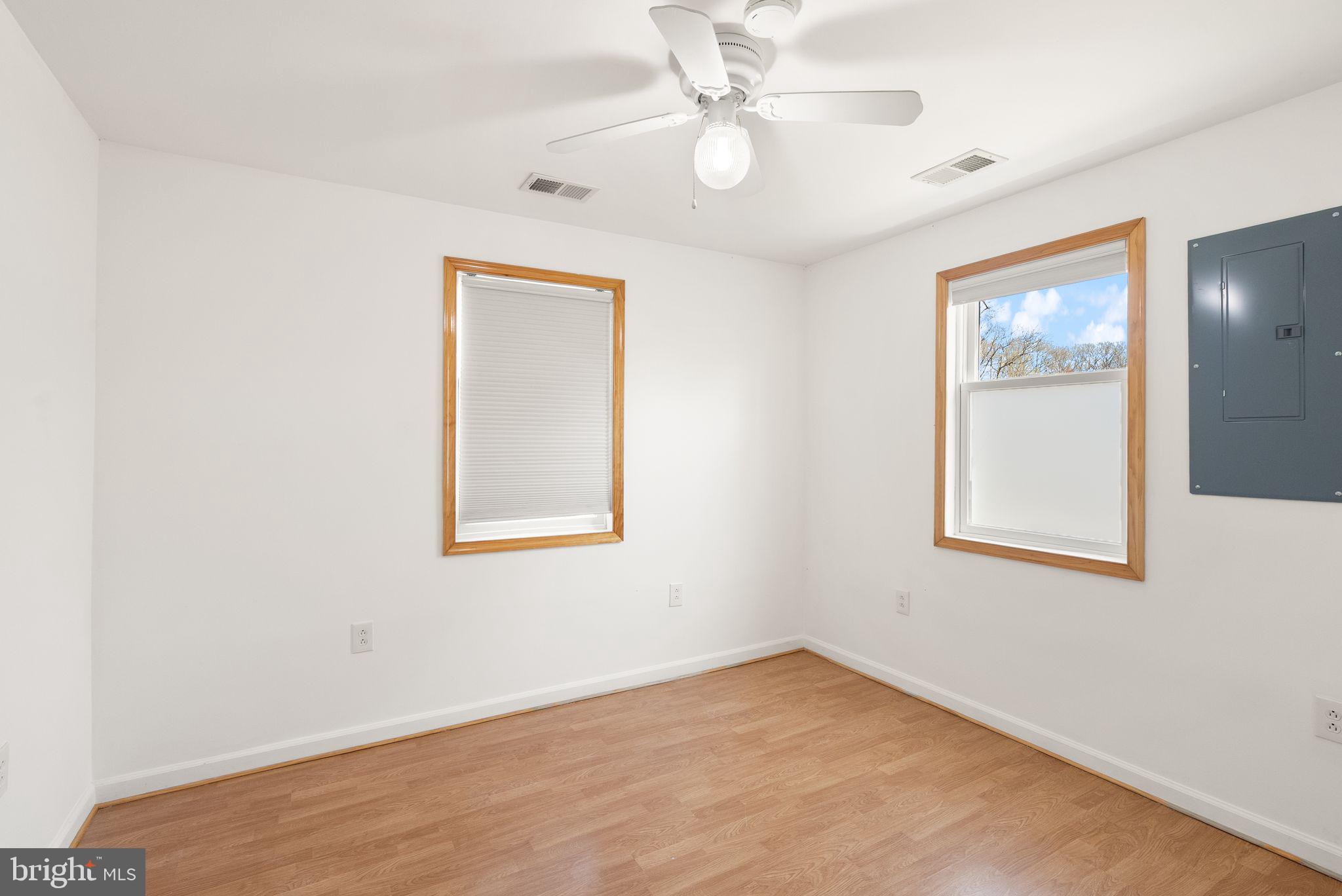 8737 Redman Street Springfield, VA 22153 - Photo 31 of 62 an empty room with a window and a fan