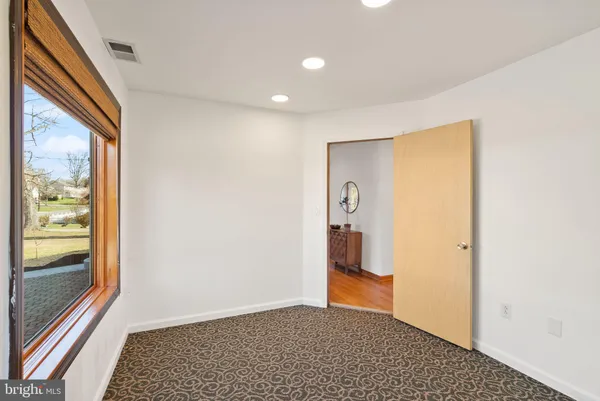 a view of a hallway with a bathroom